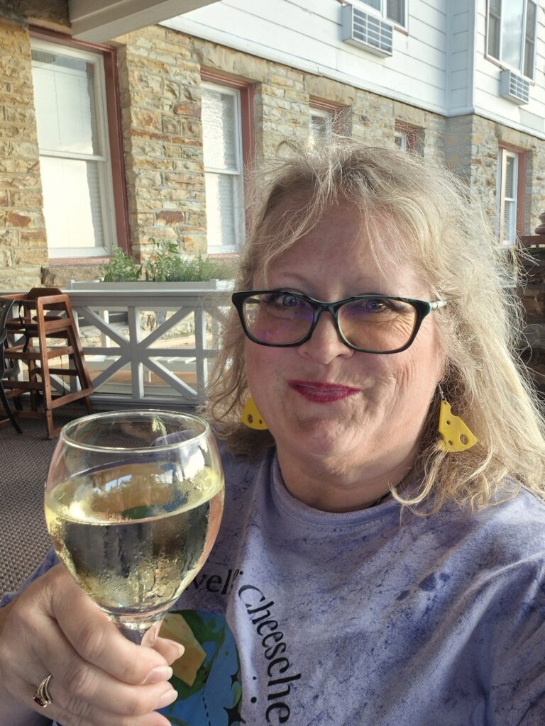 Dannelle with a glass of white wine